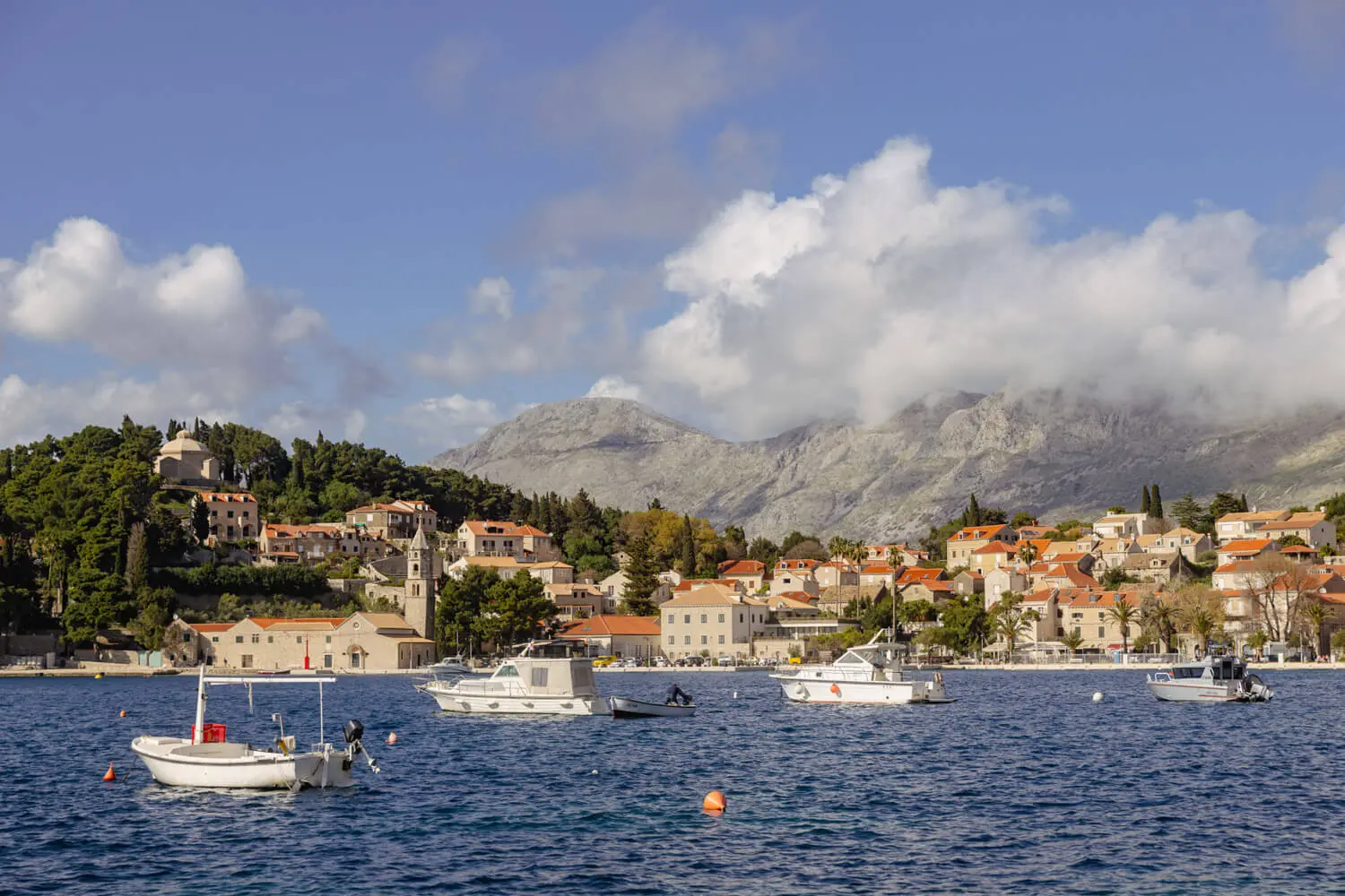 Coastal town Cavtat with boats and mountains