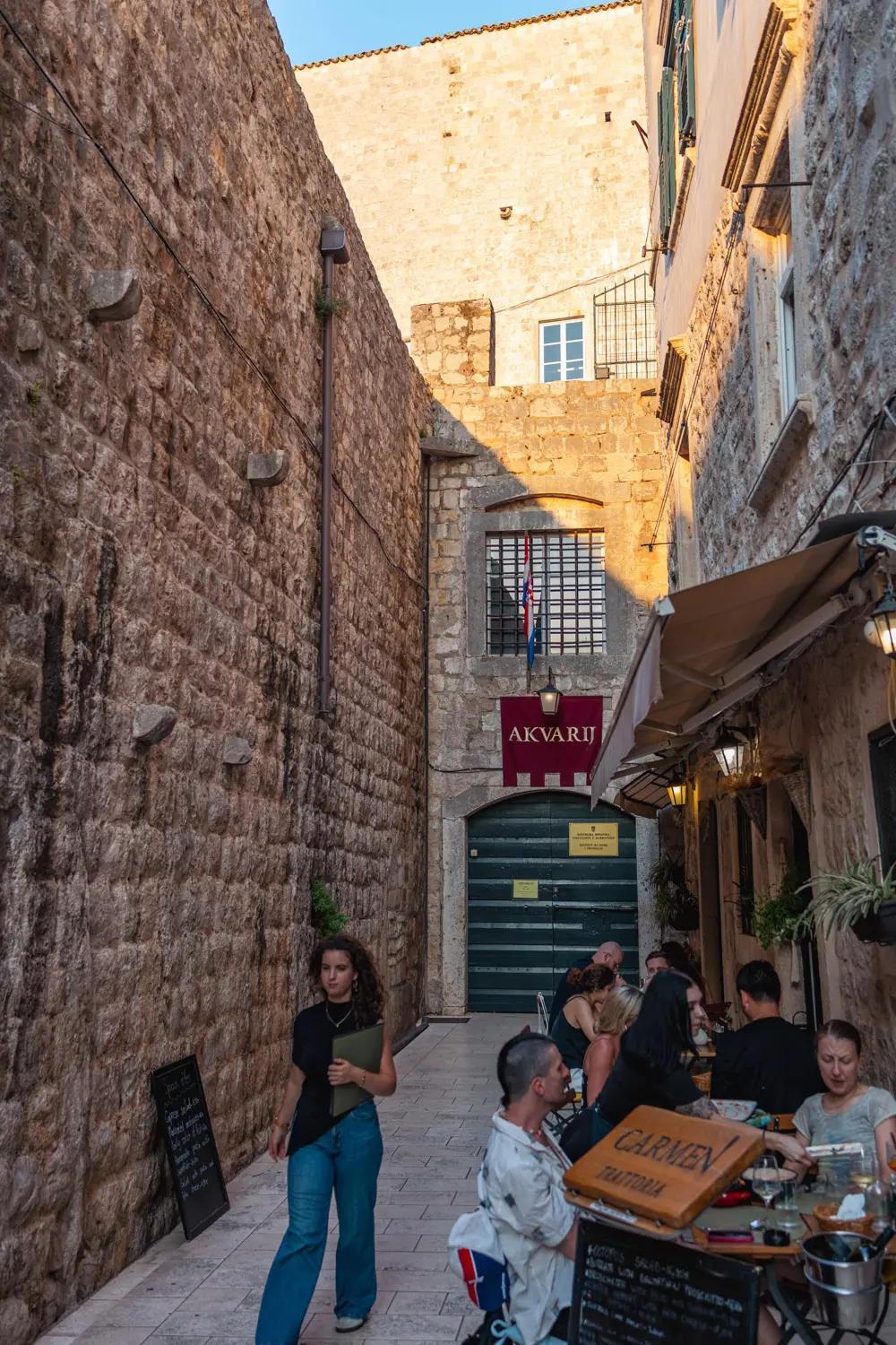 Narrow alley with outdoor dining area.